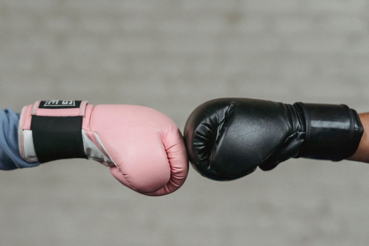 B2B Inbound Marketing VS Outbound Marketing illustrated as two boxing gloves hitting each other.