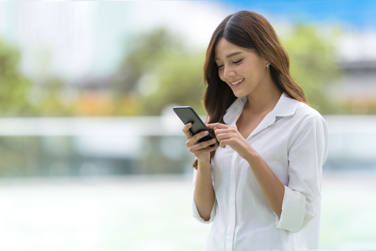 A woman browsing social media on her phone.