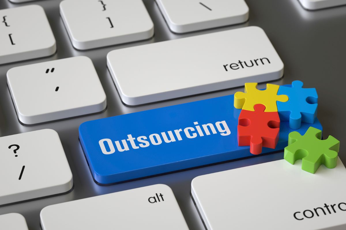 Benefits of Outsourcing SEO A keyboard with the word outsourcing written on the enter button.